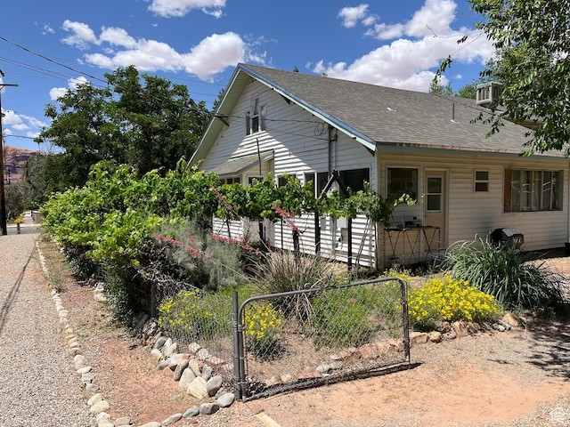 102 N 300 E, Moab, UT 84532 - view of side of property with a shingled roof and a gate