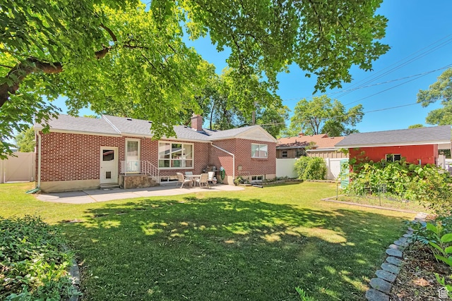 290 N 300 W, Logan, UT 84321 - back of property with a patio area, a chimney, brick siding, entry steps, and a garden