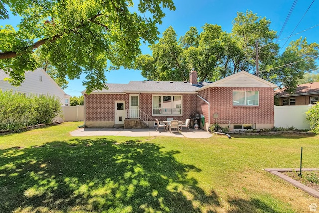 290 N 300 W, Logan, UT 84321 - back of house with a patio, a chimney, and brick siding