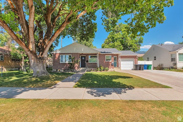 290 N 300 W, Logan, UT 84321 - view of front facade featuring brick siding, an attached garage, and concrete driveway