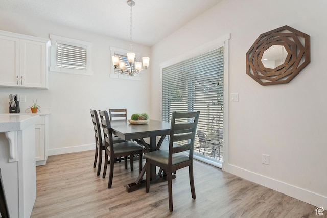 1304 E Weyburn Ln S Unit 10, Holladay, UT 84117 - dining area featuring light wood-style flooring and a chandelier