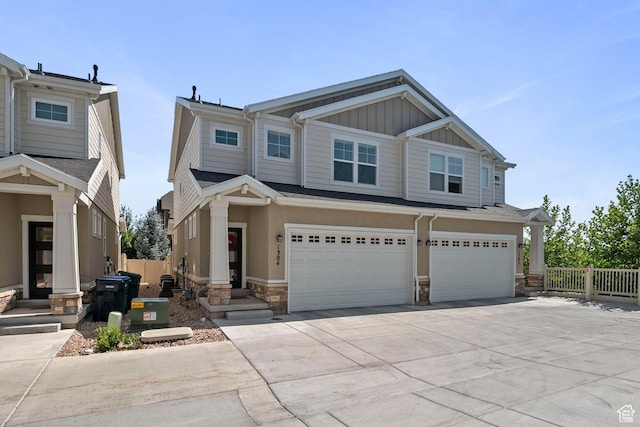 1304 E Weyburn Ln S Unit 10, Holladay, UT 84117 - view of front of home with stone siding, board and batten siding, driveway, and an attached garage