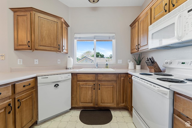 187 N Westridge Dr Unit 155, St George, UT 84770 - kitchen featuring white appliances, brown cabinetry, light flooring, and light countertops