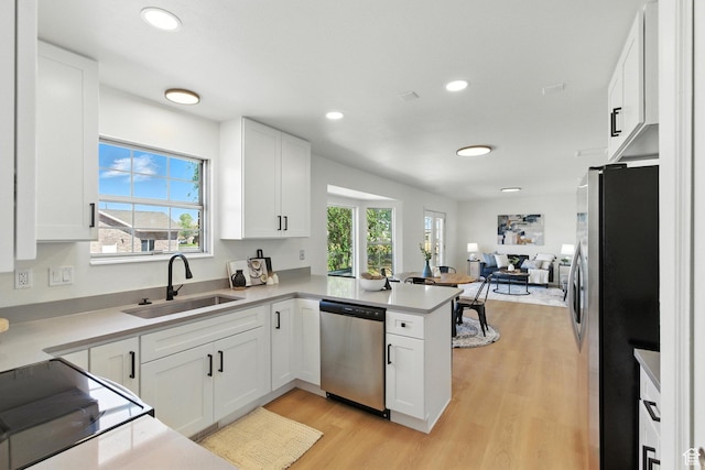 585 N 700 E, Nephi, UT 84648 - kitchen featuring stainless steel appliances, a peninsula, light wood-type flooring, white cabinets, and light countertops