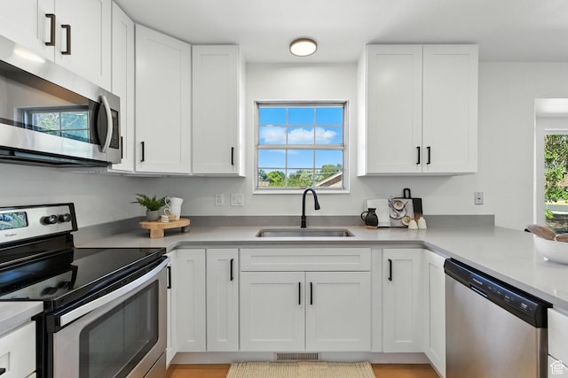 585 N 700 E, Nephi, UT 84648 - kitchen with appliances with stainless steel finishes, white cabinets, light countertops, and light wood-type flooring