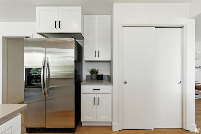 585 N 700 E, Nephi, UT 84648 - kitchen with stainless steel refrigerator with ice dispenser, white cabinets, light countertops, and light wood-type flooring