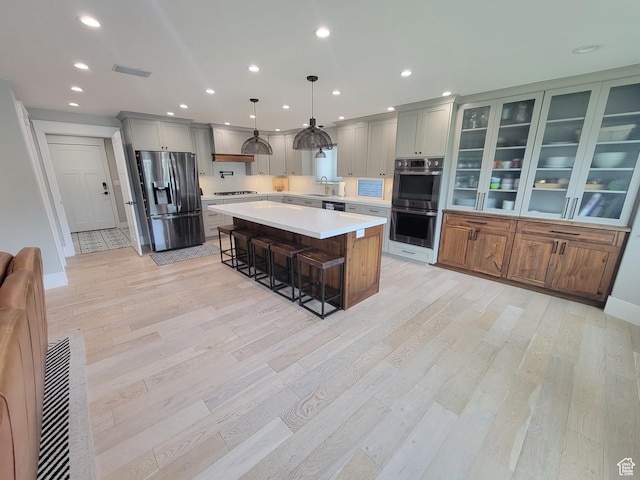 298 E 400 S, Orem, UT 84058 - kitchen with stainless steel appliances, a kitchen bar, light countertops, light wood-type flooring, and recessed lighting