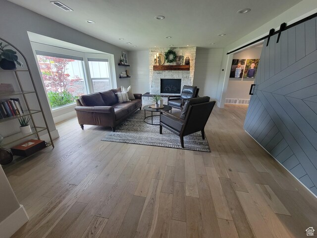 298 E 400 S, Orem, UT 84058 - living area featuring wood finished floors, a barn door, and a stone fireplace