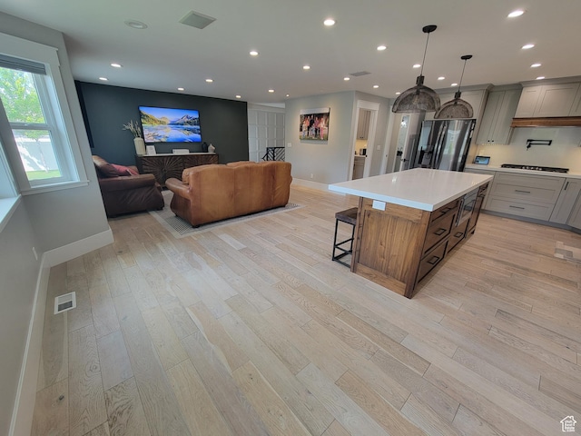 298 E 400 S, Orem, UT 84058 - kitchen featuring stainless steel fridge, light wood finished floors, a breakfast bar, and recessed lighting