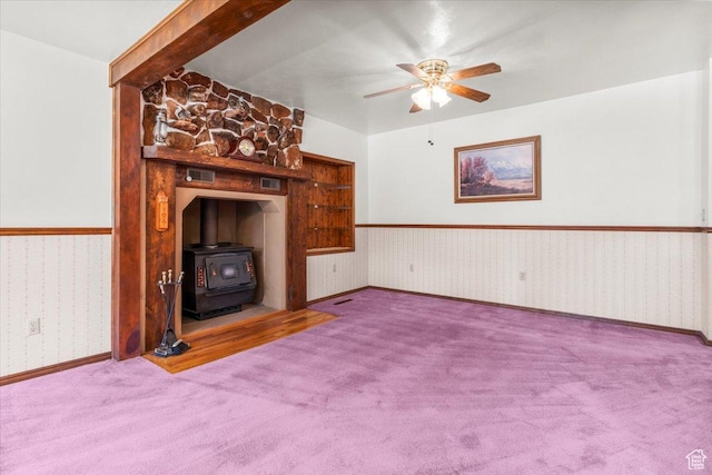 294 W 200 N, Mount Pleasant, UT 84647 - unfurnished living room featuring a wood stove, a ceiling fan, wallpapered walls, and carpet floors