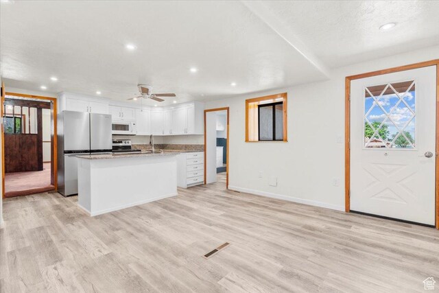 294 W 200 N, Mount Pleasant, UT 84647 - kitchen with stainless steel appliances, recessed lighting, white cabinetry, light wood-style floors, and a kitchen island with sink