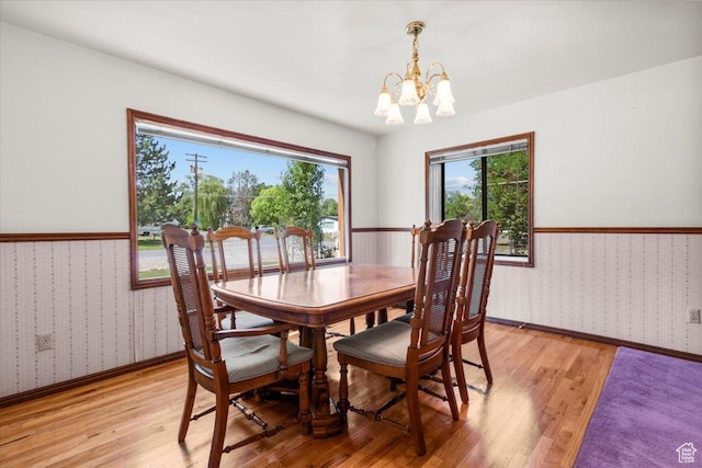 294 W 200 N, Mount Pleasant, UT 84647 - dining space featuring wallpapered walls, light wood-style flooring, a chandelier, and a wainscoted wall