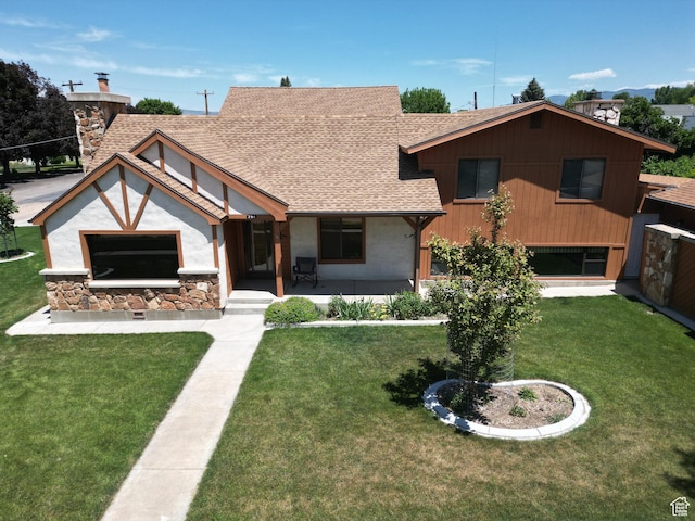 294 W 200 N, Mount Pleasant, UT 84647 - view of front of home featuring roof with shingles, a front lawn, stone siding, and a chimney