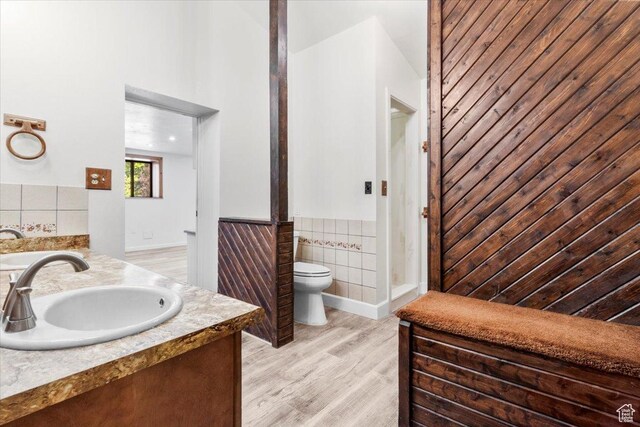 294 W 200 N, Mount Pleasant, UT 84647 - bathroom featuring wainscoting, tile walls, double vanity, and wood finished floors