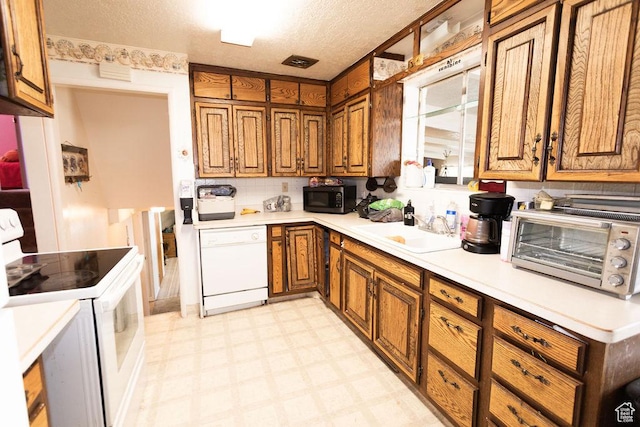 960 N 100 W, Tremonton, UT 84337 - kitchen with white appliances, brown cabinets, light floors, light countertops, and a textured ceiling