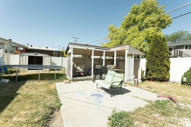 960 N 100 W, Tremonton, UT 84337 - fenced backyard featuring a trampoline and a patio area