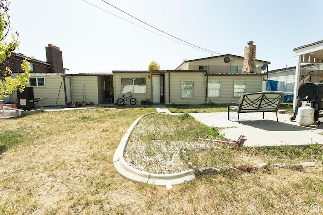 960 N 100 W, Tremonton, UT 84337 - rear view of property with a patio area and a yard