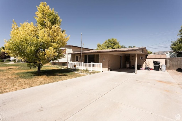 960 N 100 W, Tremonton, UT 84337 - tri-level home with driveway, a carport, and a porch