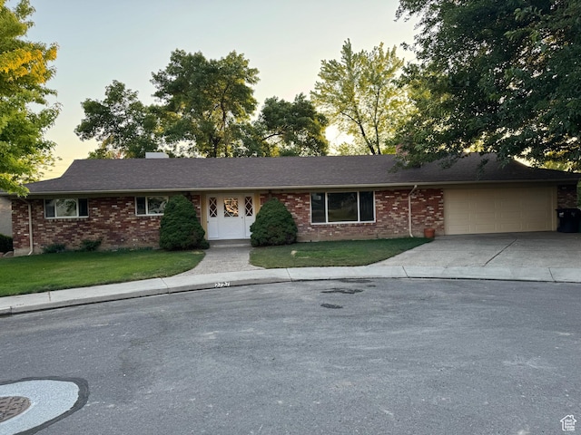 2727 N 700 E, Provo, UT 84604 - ranch-style home featuring a garage, concrete driveway, brick siding, and a lawn