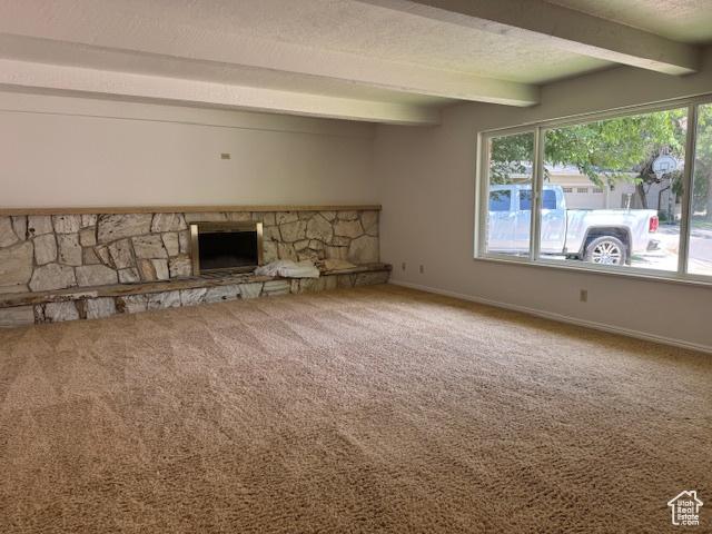 2727 N 700 E, Provo, UT 84604 - unfurnished living room with beamed ceiling, a fireplace, plenty of natural light, and carpet