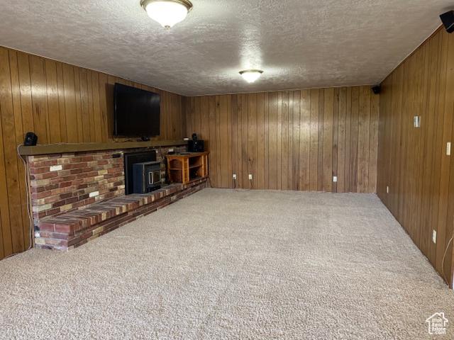 2727 N 700 E, Provo, UT 84604 - unfurnished living room featuring a textured ceiling, carpet flooring, and wood walls