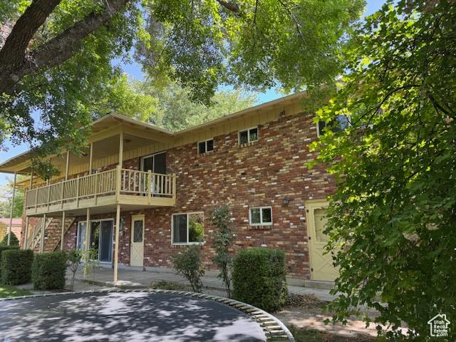 2727 N 700 E, Provo, UT 84604 - back of property featuring brick siding, a patio area, stairway, and a deck