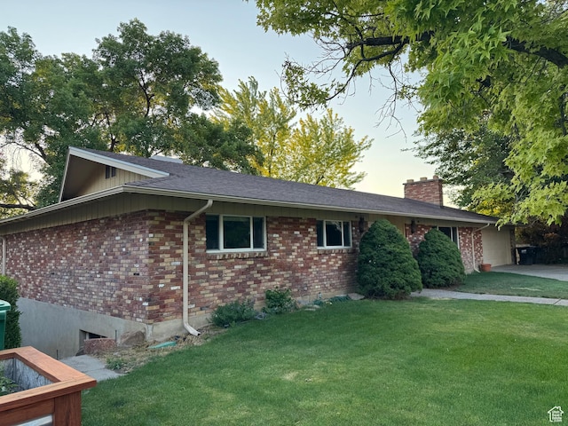2727 N 700 E, Provo, UT 84604 - view of side of property featuring brick siding, a lawn, a chimney, and a garage