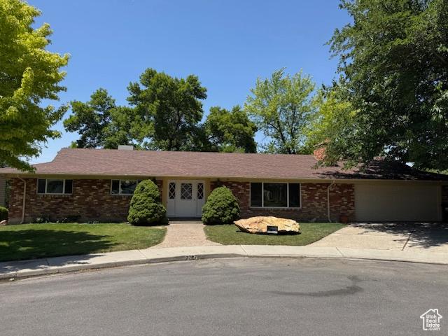 2727 N 700 E, Provo, UT 84604 - single story home with a front lawn, brick siding, driveway, and an attached garage