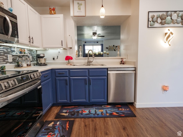 1193 W Dun Robin Ct, Murray, UT 84123 - kitchen featuring stainless steel appliances, blue cabinets, a ceiling fan, dark wood-style flooring, and light countertops