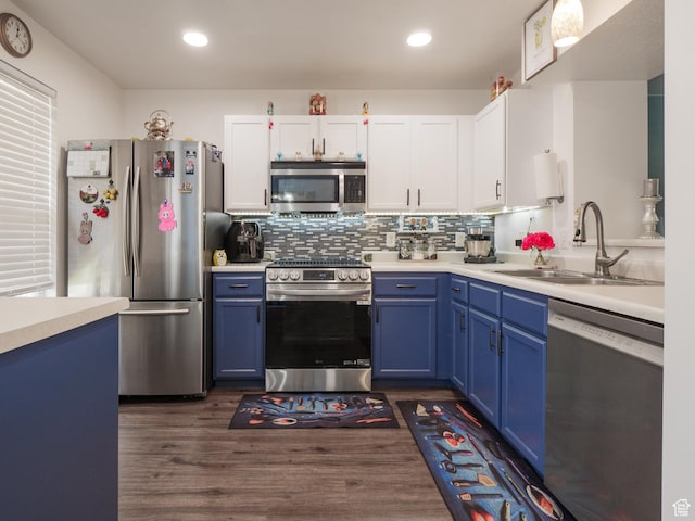 1193 W Dun Robin Ct, Murray, UT 84123 - kitchen featuring appliances with stainless steel finishes, blue cabinetry, light countertops, white cabinets, and recessed lighting