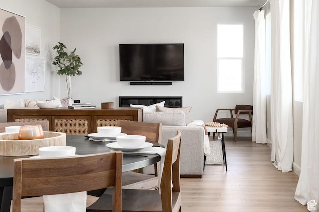8072 S 300 E Unit 246, Midvale, UT 84070 - dining room with light wood-style flooring and a glass covered fireplace