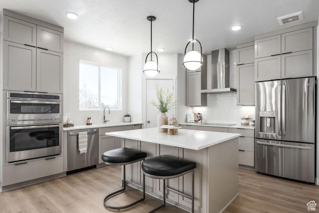 8072 S 300 E Unit 246, Midvale, UT 84070 - kitchen with stainless steel appliances, wall chimney range hood, gray cabinetry, decorative backsplash, and recessed lighting