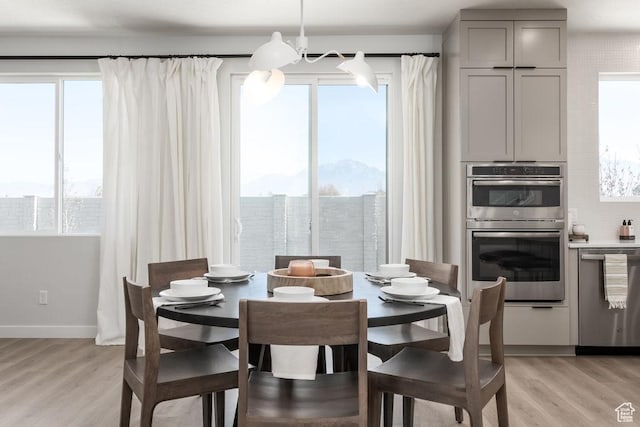8072 S 300 E Unit 246, Midvale, UT 84070 - dining area featuring light wood-style flooring and a chandelier
