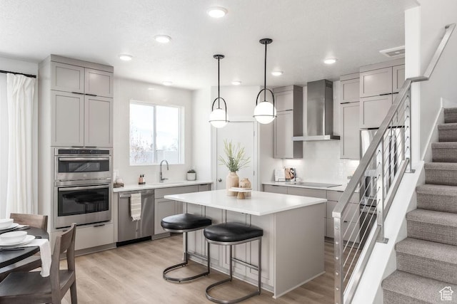 8072 S 300 E Unit 246, Midvale, UT 84070 - kitchen with stainless steel appliances, wall chimney range hood, gray cabinetry, tasteful backsplash, and recessed lighting