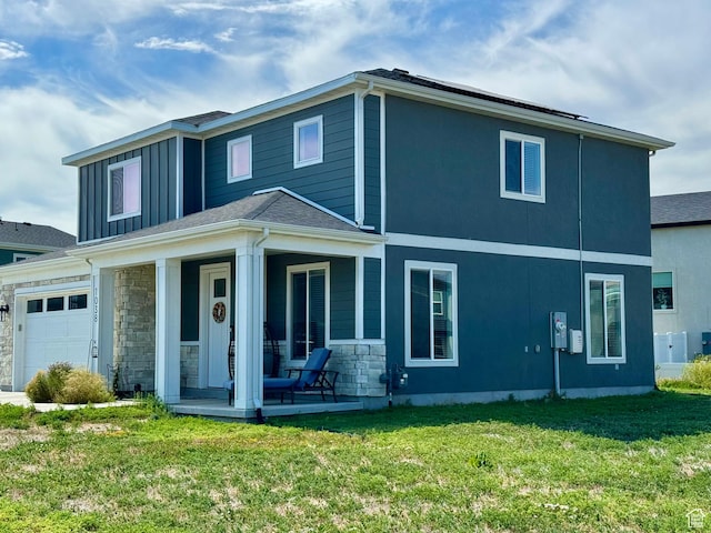 1038 W 980 S Unit 312, American Fork, UT 84003 - back of house featuring a porch, a yard, stone siding, and an attached garage