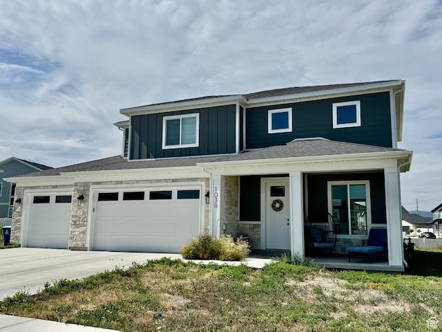 1038 W 980 S Unit 312, American Fork, UT 84003 - view of front of home with covered porch, board and batten siding, stone siding, and driveway