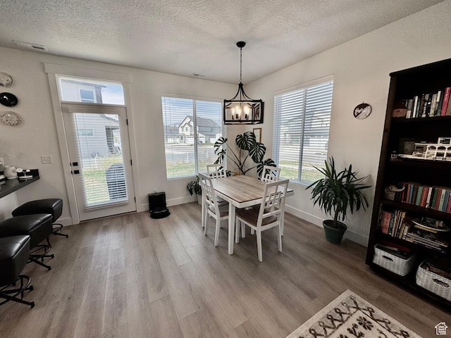 1038 W 980 S Unit 312, American Fork, UT 84003 - dining space with plenty of natural light, a textured ceiling, wood finished floors, and a chandelier