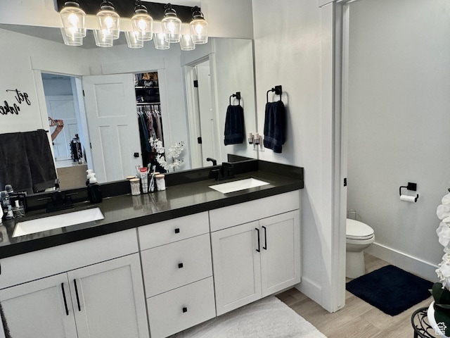 1038 W 980 S Unit 312, American Fork, UT 84003 - bathroom featuring double vanity, wood finished floors, and a spacious closet
