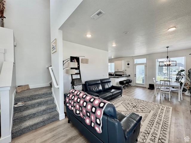 1038 W 980 S Unit 312, American Fork, UT 84003 - living area with a chandelier, stairway, light wood finished floors, a textured ceiling, and recessed lighting