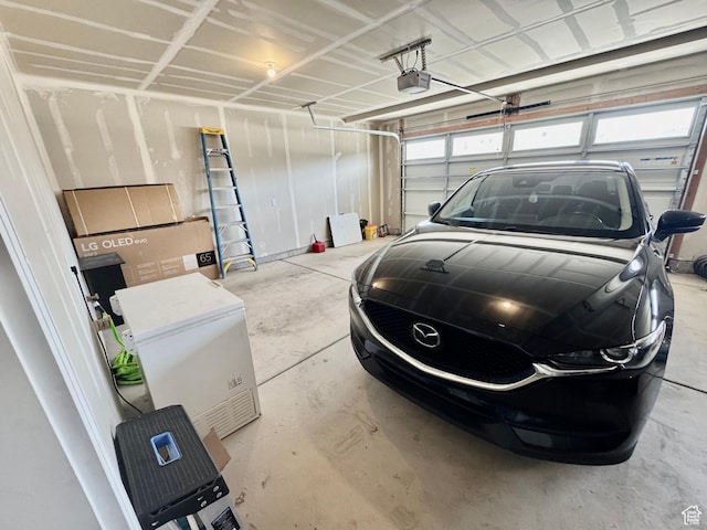 1038 W 980 S Unit 312, American Fork, UT 84003 - garage featuring a garage door opener and refrigerator