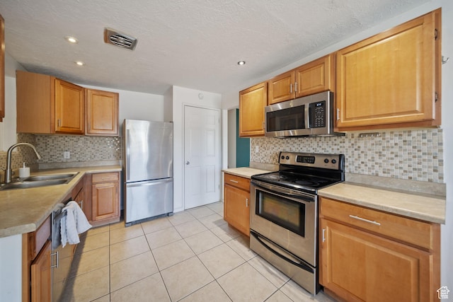 5154 S Lori Way, Salt Lake City, UT 84117 - kitchen featuring stainless steel appliances, light tile patterned floors, decorative backsplash, light countertops, and recessed lighting