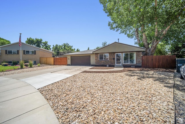 5154 S Lori Way, Salt Lake City, UT 84117 - ranch-style house featuring concrete driveway, a garage, and stone siding