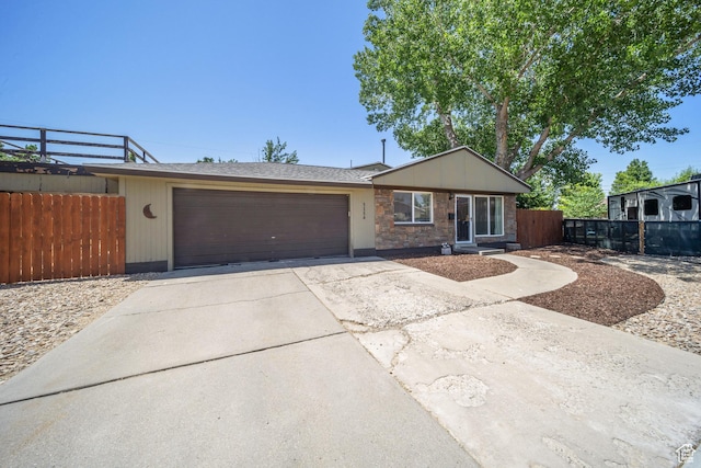 5154 S Lori Way, Salt Lake City, UT 84117 - view of front of home with a garage, driveway, and stone siding
