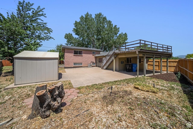 5154 S Lori Way, Salt Lake City, UT 84117 - rear view of house featuring stairs, a patio area, a fenced backyard, a storage shed, and a wooden deck