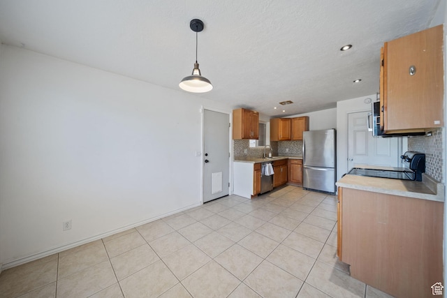5154 S Lori Way, Salt Lake City, UT 84117 - kitchen with stainless steel appliances, tasteful backsplash, light countertops, brown cabinets, and light tile patterned floors