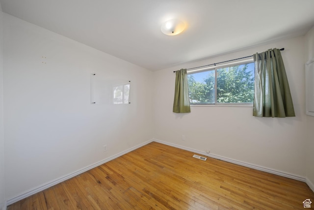5154 S Lori Way, Salt Lake City, UT 84117 - empty room with light wood-type flooring and healthy amount of natural light