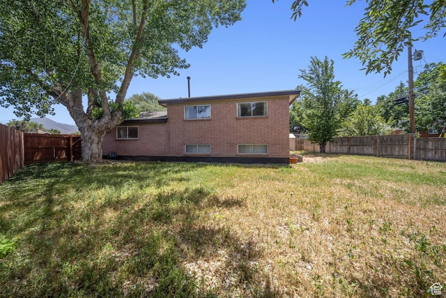 5154 S Lori Way, Salt Lake City, UT 84117 - back of property featuring a fenced backyard and brick siding