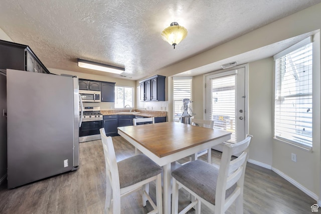 637 W Chase Ln, Centerville, UT 84014 - dining area featuring a textured ceiling and wood finished floors