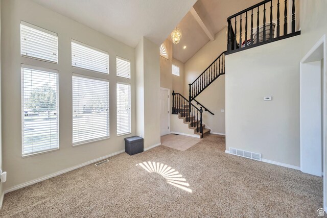 637 W Chase Ln, Centerville, UT 84014 - entrance foyer featuring high vaulted ceiling, carpet, plenty of natural light, beamed ceiling, and stairway