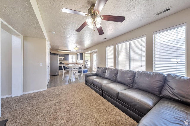 637 W Chase Ln, Centerville, UT 84014 - living room with a textured ceiling, a ceiling fan, and light colored carpet